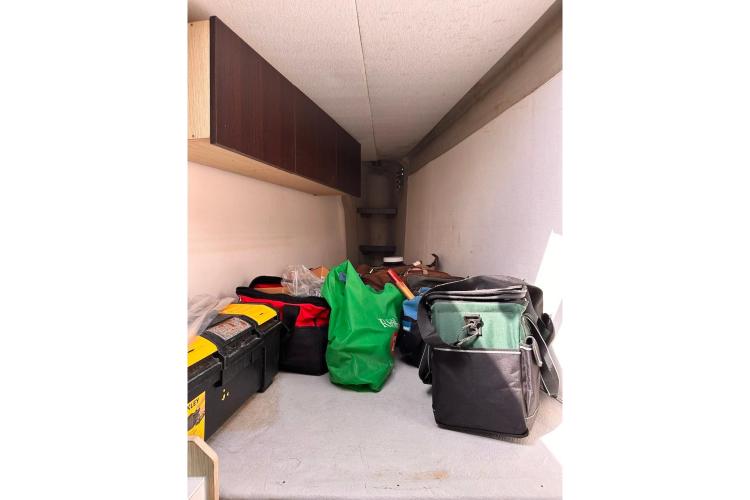 Storage compartment on 2016 Fountaine Pajot Ipanema 58 with bags and tools.