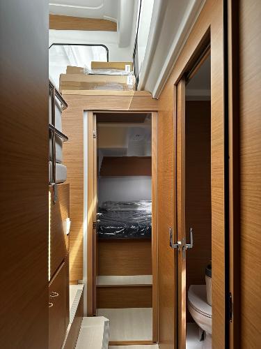 2024 Excess 11 yacht interior with wooden finish, compact cabin, and modern design.