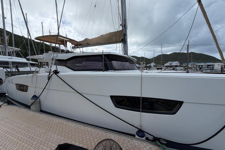 2020 Fountaine Pajot Astrea 42 catamaran docked at marina, side view.