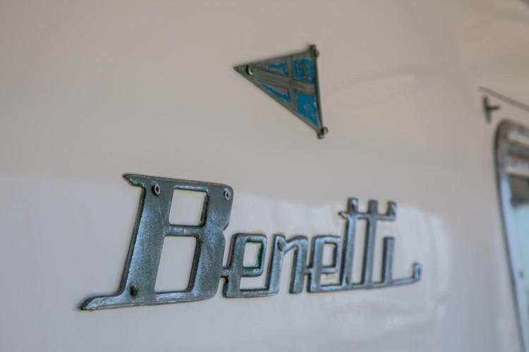 Close-up of 1972 Benetti 33 yacht logo and emblem on white surface.