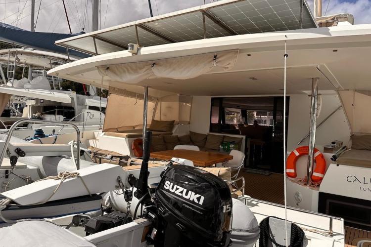 2016 Fountaine Pajot Ipanema 58 catamaran with outdoor seating and Suzuki outboard motor.