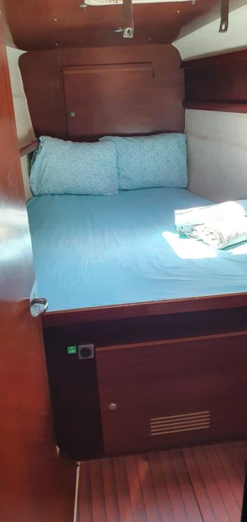 Cozy cabin interior of 1999 Fountaine Pajot Bahia 46 catamaran with wooden finish.