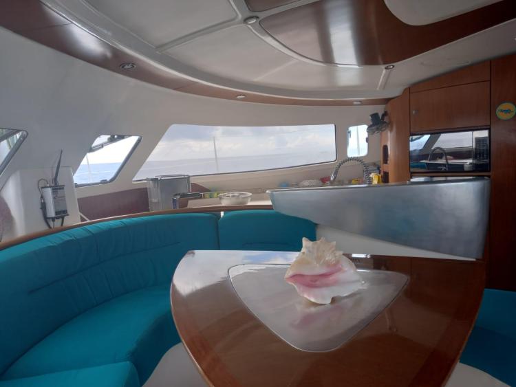 Interior of 1999 Fountaine Pajot Bahia 46 catamaran with modern seating and table.