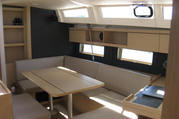 Interior of 2019 Beneteau Oceanis 46.1 yacht, featuring a modern dining area with ample seating.