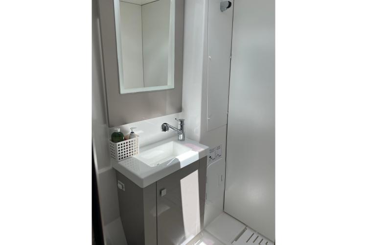 Modern bathroom sink in 2023 Fountaine Pajot Astrea 42 Catamaran, featuring sleek design and mirror.
