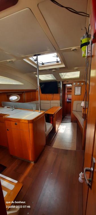 Interior of 2007 Elan Impression 434 yacht with wood finish and seating area.