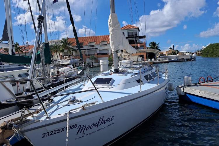 1986 Dufour CATALINA sailboat docked in marina under blue sky.