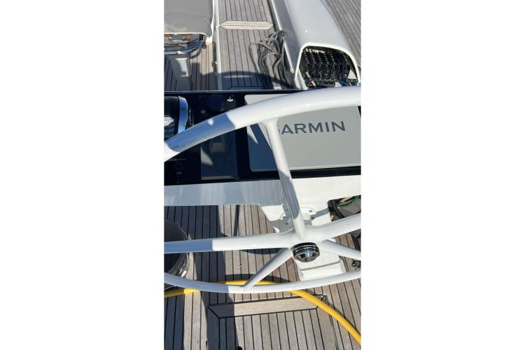Steering wheel and Garmin display on 2024 Beneteau First 53 yacht deck.