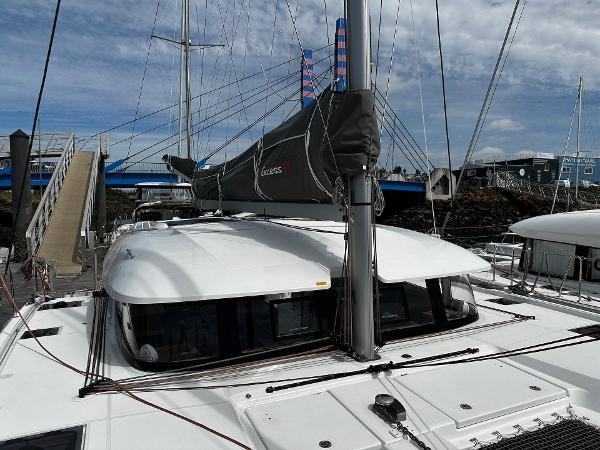 2024 Excess 11 catamaran docked at marina with sails furled.