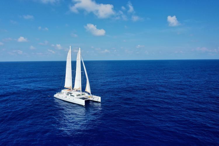 Sailing catamaran Etoile Marine NAUTILUS 360, 2004, on open ocean under clear skies.