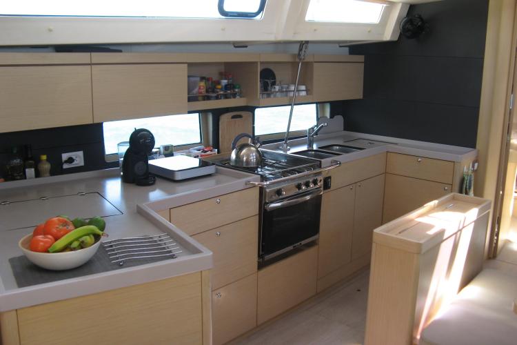 Modern kitchen interior of 2019 Beneteau Oceanis 46.1 yacht with sleek cabinetry and appliances.