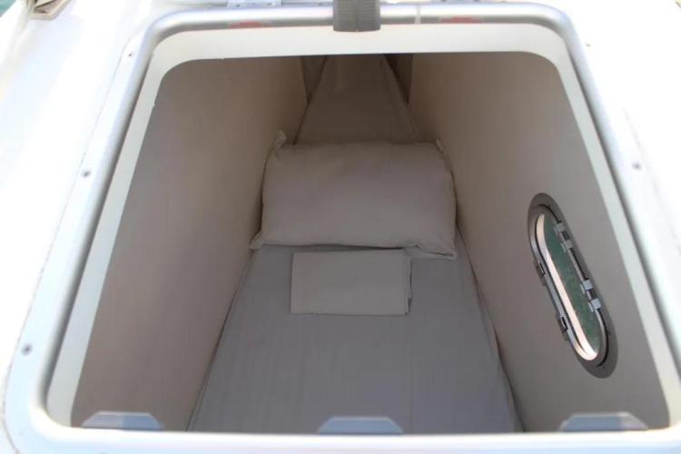 Cabin interior of 2017 Fountaine Pajot SABA 50 catamaran with bedding and porthole.