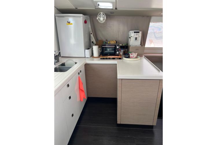 Modern kitchen interior of 2023 Fountaine Pajot Astrea 42 Catamaran with appliances and sleek design.
