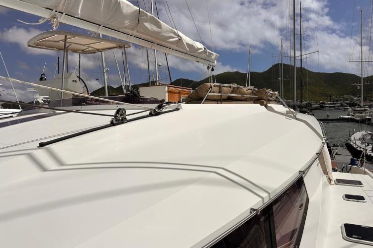 2016 Fountaine Pajot Ipanema 58 yacht docked in a marina, sunny day.