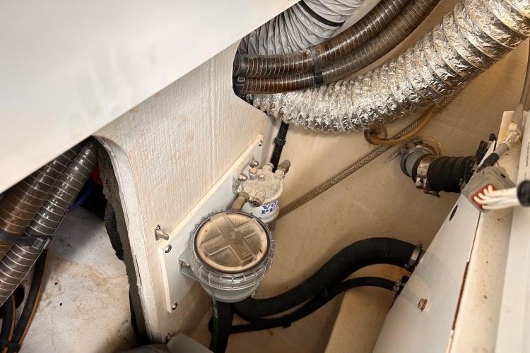 Engine room of 2016 Fountaine Pajot Ipanema 58 with hoses and mechanical components.