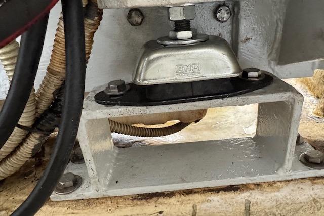 Engine mount detail on 2004 Etoile Marine Maxi Cat 24, featuring cables and metal components.