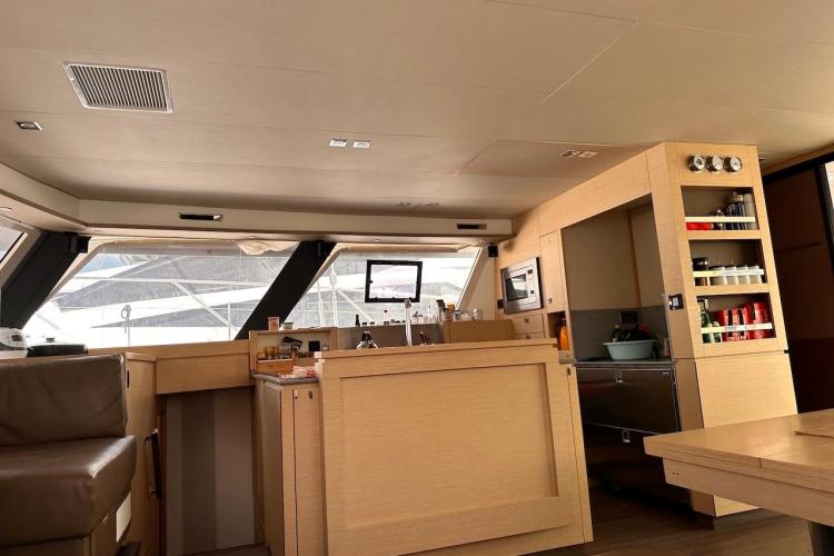 Interior of 2016 Fountaine Pajot Ipanema 58 yacht, featuring modern kitchen and seating area.