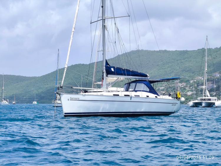 Sailing yacht Beneteau Cyclades 43.3, 2005 model, anchored in scenic bay.