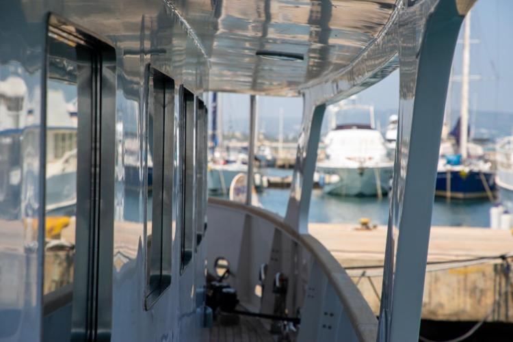 Side view of a 1972 Benetti 33 yacht docked at a marina.