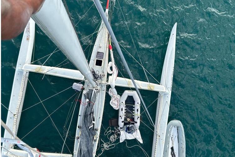 Aerial view of 1994 Coulombel Trimaran sailboat on the ocean.