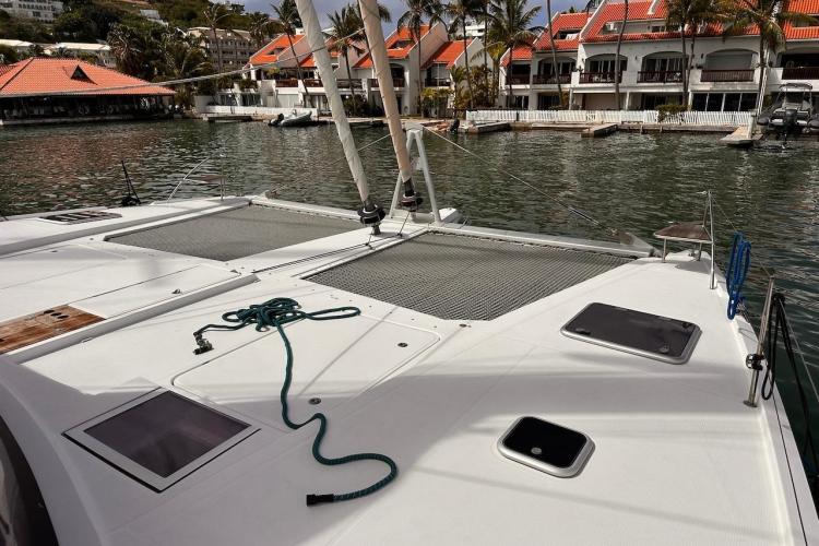 2016 Fountaine Pajot Ipanema 58 catamaran docked near waterfront buildings.