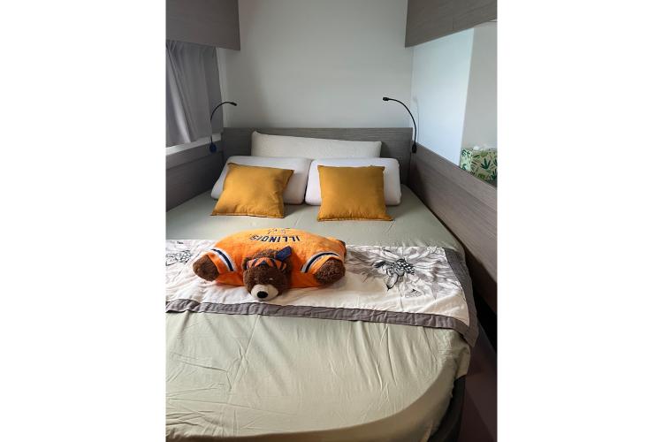 Cozy bedroom in 2023 Fountaine Pajot Astrea 42 Catamaran with plush bear decor.