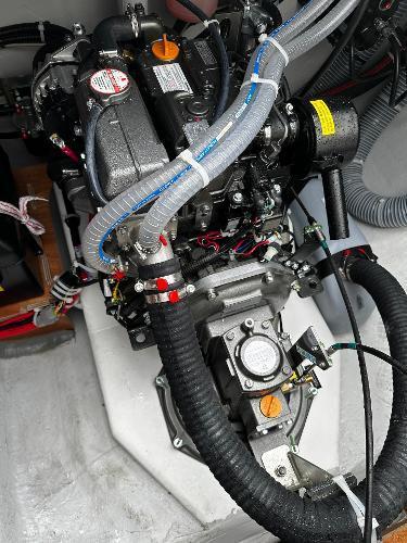 2024 Excess 11 engine compartment with visible components and hoses.