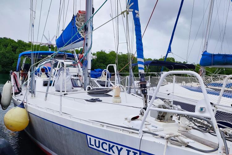 Sailboat "Lucky II" docked, Custom Patago 40, 2019 model, with blue sails and equipment.