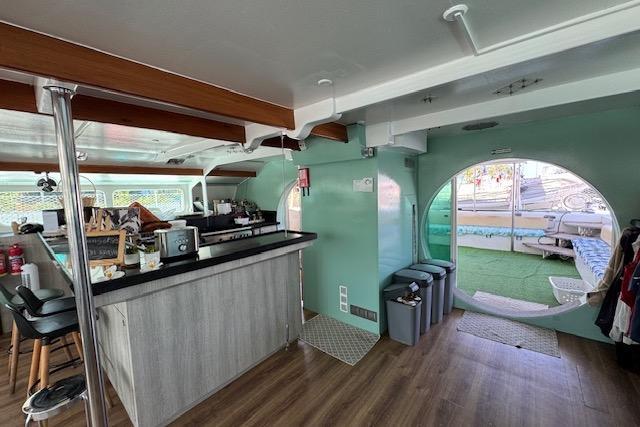 Interior of 2004 Etoile Marine Maxi Cat 24 catamaran with modern kitchen and circular window.