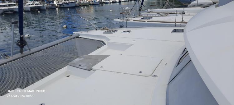 2017 Fountaine Pajot SABA 50 catamaran docked in a marina, showcasing deck and netting.
