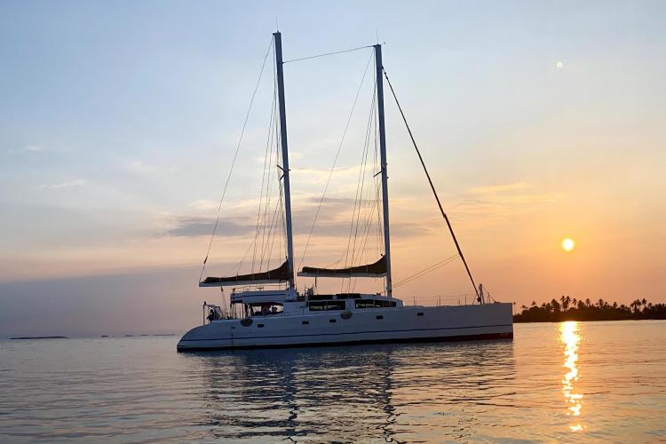 Sailing yacht Etoile Marine NAUTILUS 360, 2004, at sunset on calm waters.