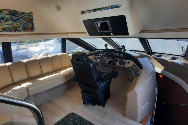 Interior of 2000 Carver 530 Voyager Pilothouse with helm and seating area.
