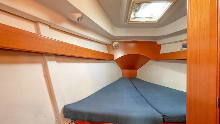 Cozy cabin interior of 2005 Beneteau Cyclades 43.3 sailboat with wooden accents and skylight.