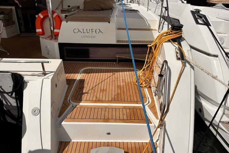 2016 Fountaine Pajot Ipanema 58 yacht with teak deck and mooring ropes.