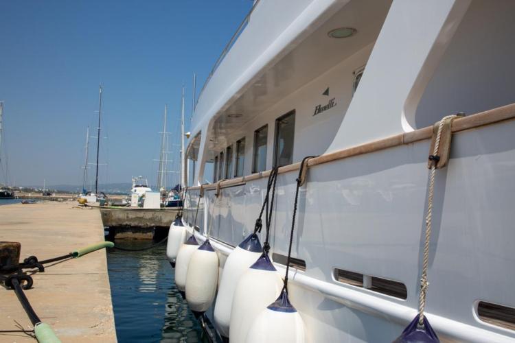1972 Benetti 33 yacht docked at a marina, side view with fenders.
