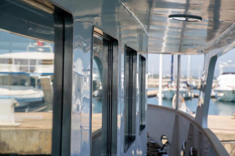 Side view of a 1972 Benetti 33 yacht docked at a marina.
