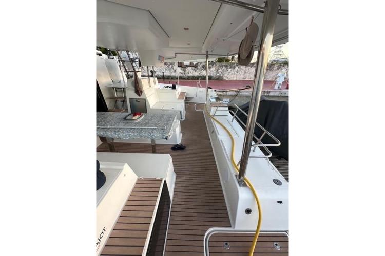 2023 Fountaine Pajot Elba yacht deck with seating and table, docked at marina.