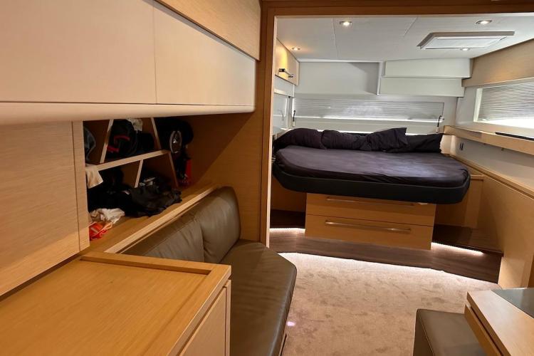 Interior of 2016 Fountaine Pajot Ipanema 58 yacht, featuring a cozy bedroom and seating area.