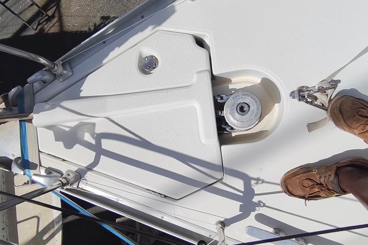 Deck of 2000 Jeanneau Sun Odyssey 37 sailboat with winch and foot visible.