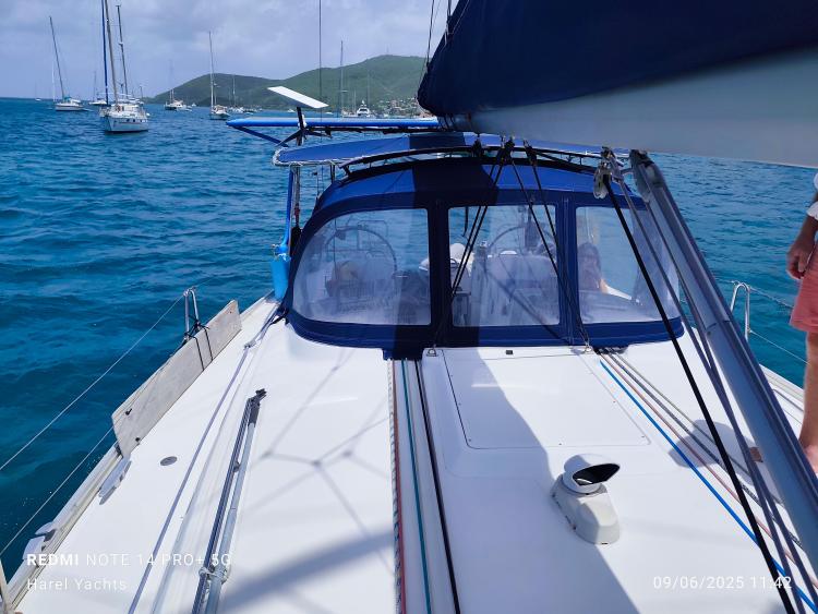 Beneteau Cyclades 43.3 sailboat on blue water, 2005 model, with scenic background.