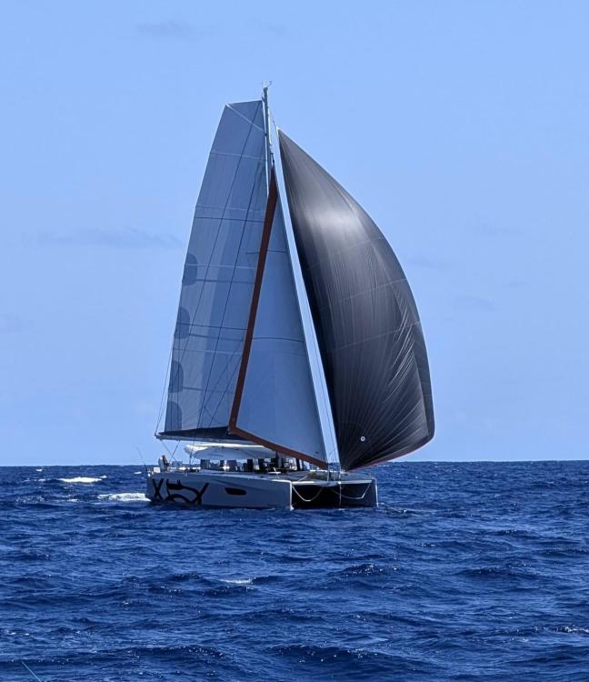 2024 Excess 14 sailboat navigating open sea with full sails.