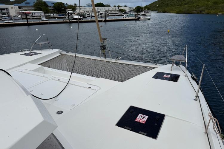 2020 Fountaine Pajot Astrea 42 catamaran docked in a marina, showcasing spacious deck.
