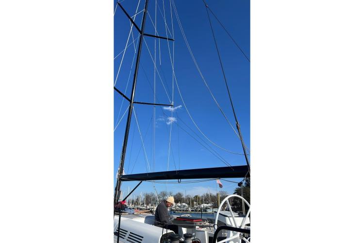 2024 Beneteau First 53 sailboat mast and rigging against clear blue sky.