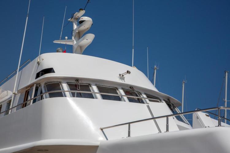 1972 Benetti 33 yacht, sleek white design against clear blue sky.