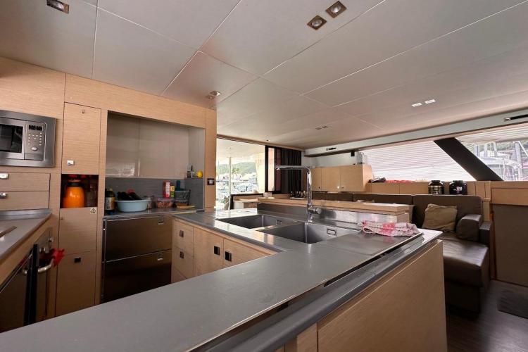 Modern kitchen interior of 2016 Fountaine Pajot Ipanema 58 catamaran, featuring sleek design and amenities.