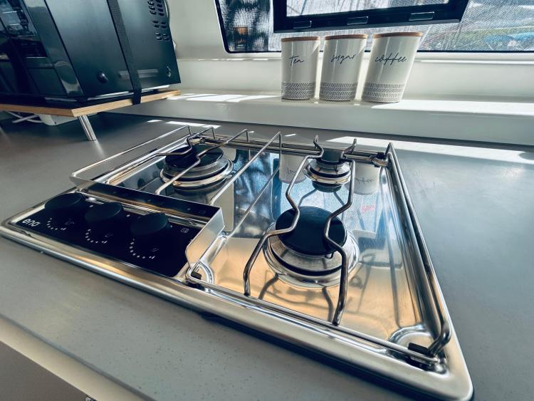 Modern kitchen stove in a 2024 Excess 14 yacht, with sleek design and coffee canisters.