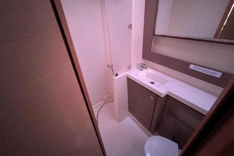 Bathroom interior of 2017 Fountaine Pajot SABA 50 yacht, featuring sink, mirror, and shower.