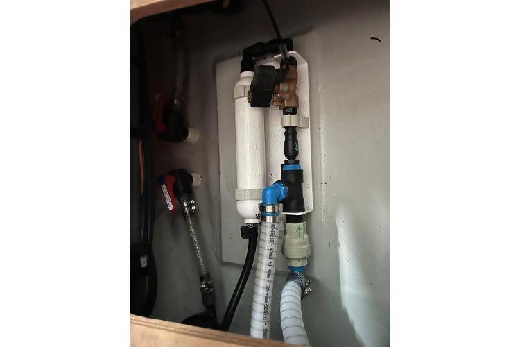 Plumbing system inside 2023 Fountaine Pajot Astrea 42 Catamaran, featuring pipes and connectors.
