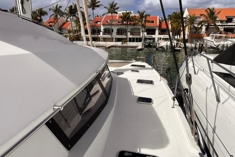 2016 Fountaine Pajot Ipanema 58 catamaran docked near waterfront homes.