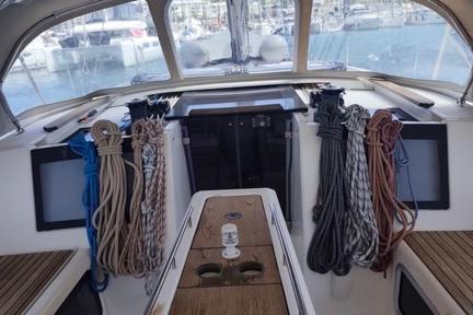 2017 Dufour 460 Grand Large yacht cockpit with ropes and wooden seating.